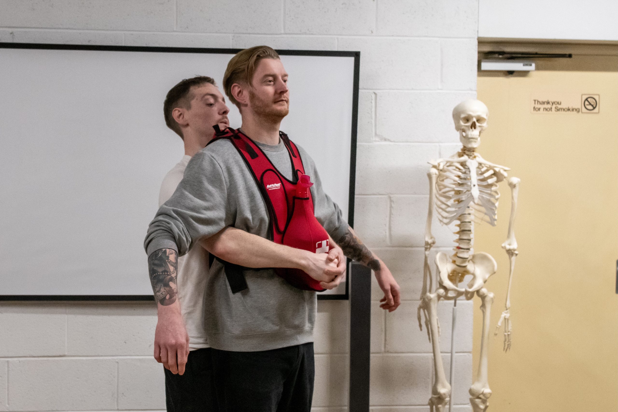 Students managing choking during outdoor first aid training